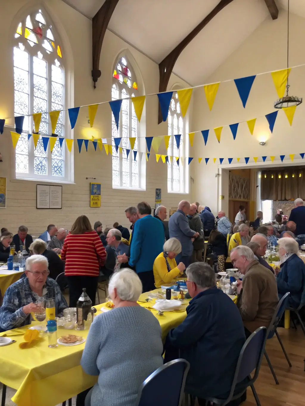 A photograph of the local community participating in a cultural event held at the Sainte-Croix church, demonstrating the church's role as a community hub and the importance of preserving it for social gatherings.